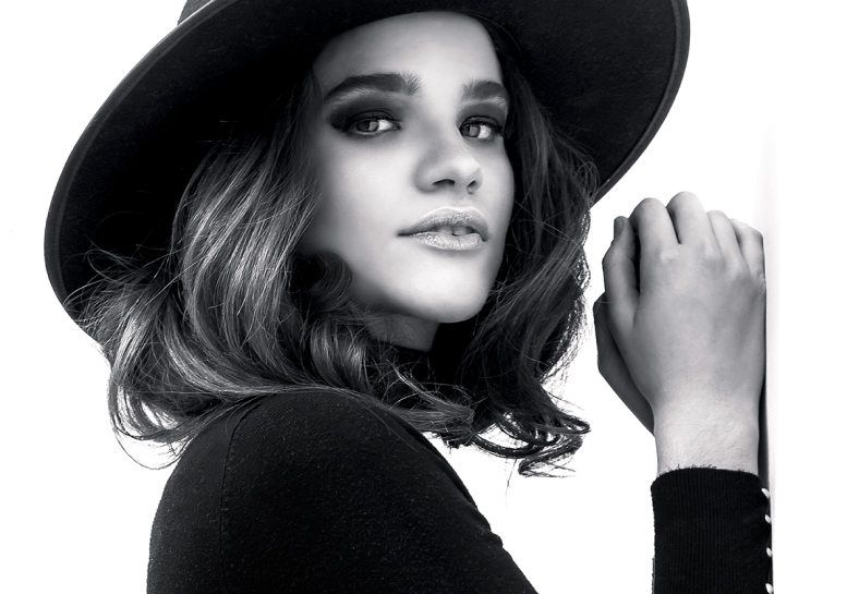 Black & white portrait — woman in a wide-brim hat.