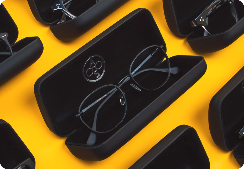 Eyewear flat lay — cases and frames on a yellow background.