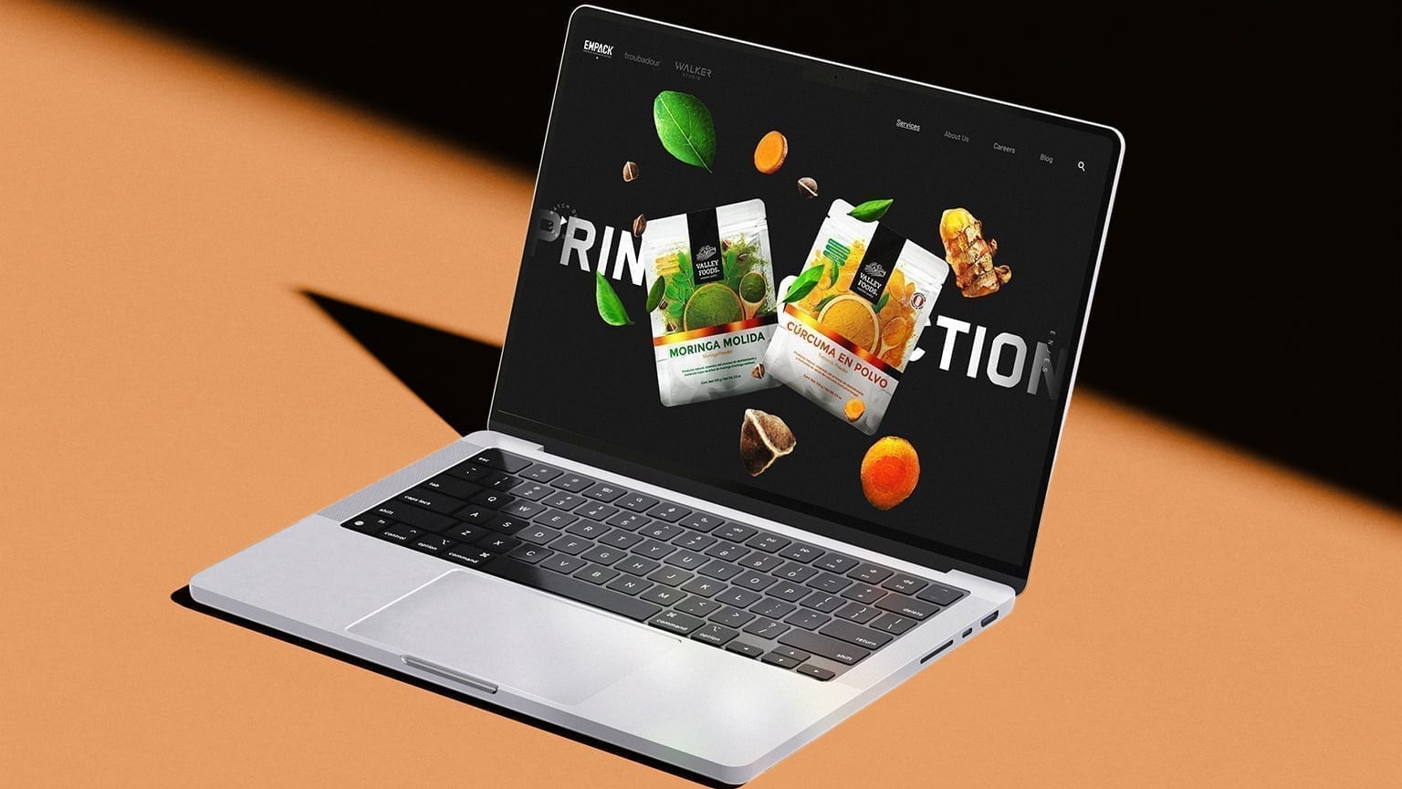 Empack print production services page on a laptop mockup.