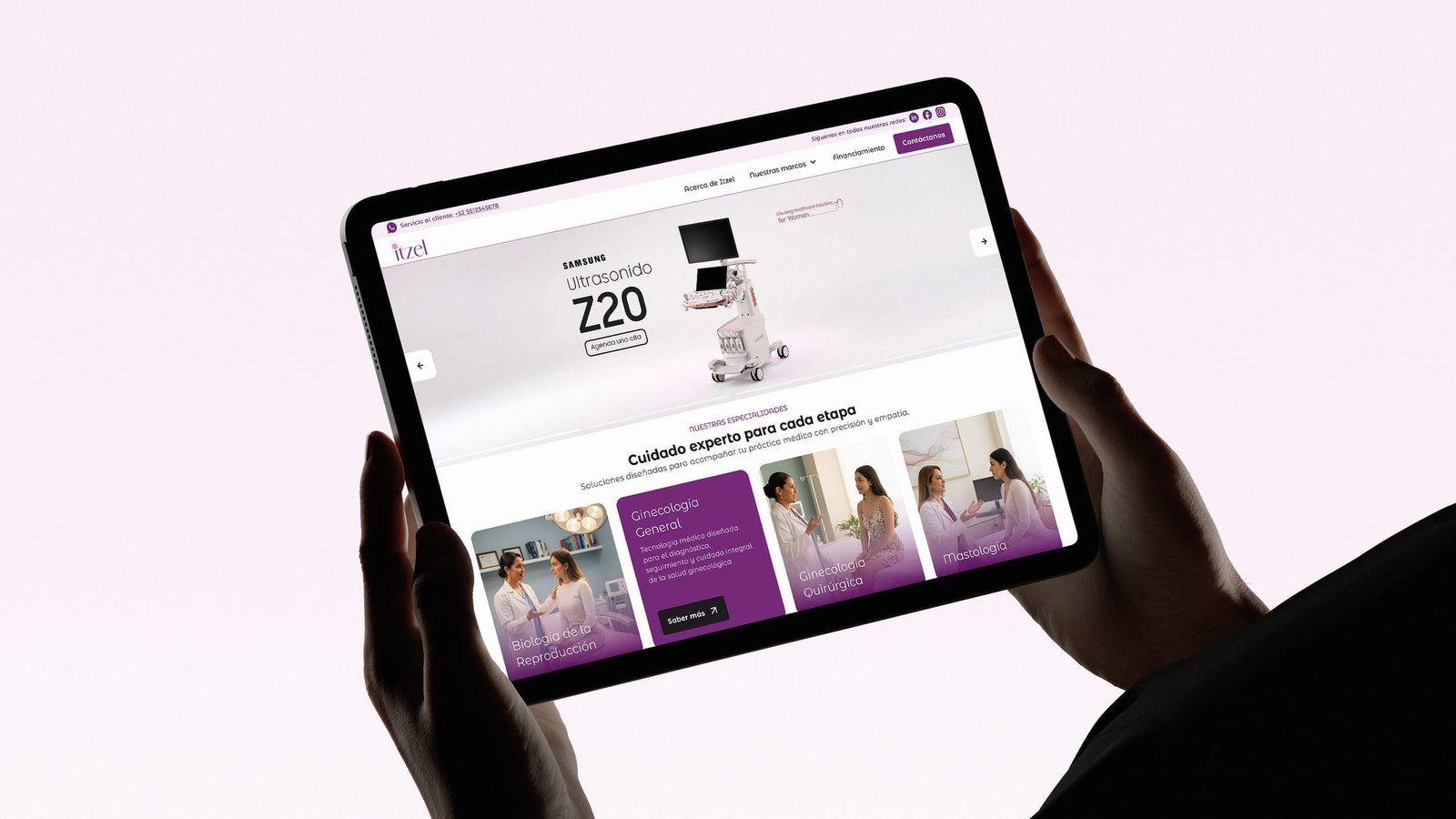 Tablet held in hands showing the Itzel women's health platform homepage with clinical specialties and medical products.