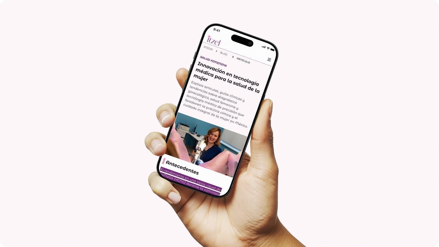 Hand holding a smartphone showing an Itzel clinical article on medical technology for women's health.