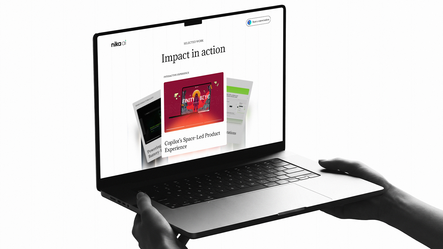 Laptop displaying the Nika AI Impact in action project showcase with a dimensional editorial card carousel.