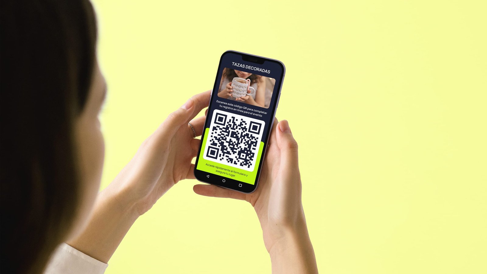Woman holding a phone that shows a Tazas decoradas QR code to complete event registration.