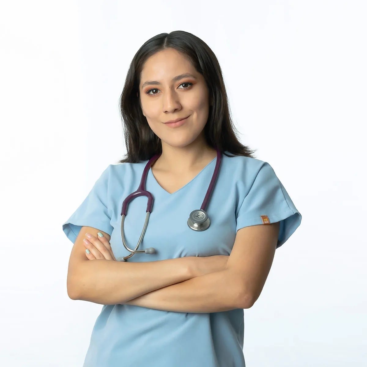Professional portrait of veterinarian Cynthia in teal scrubs.
