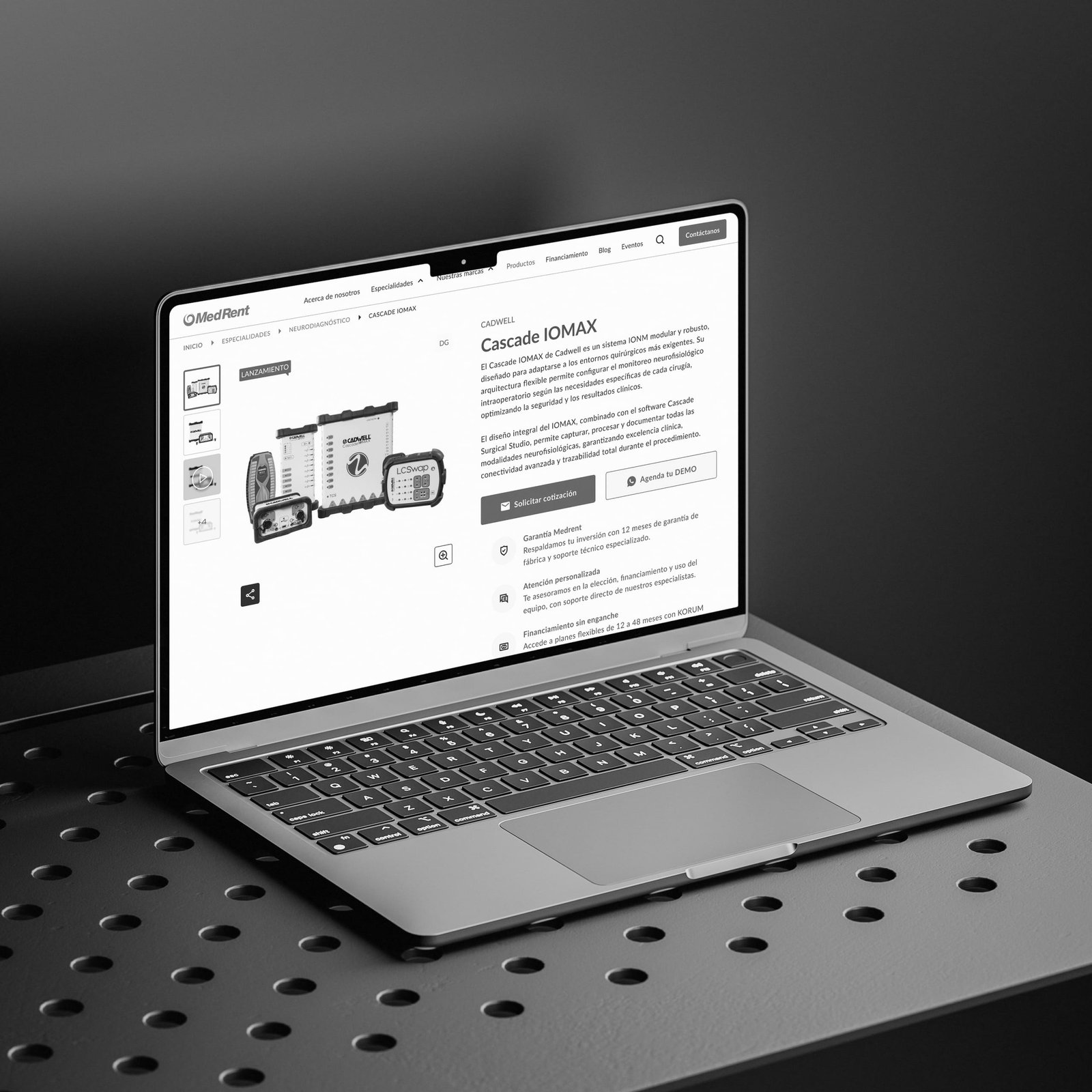 Laptop on a perforated metal table showing a medical equipment product page.