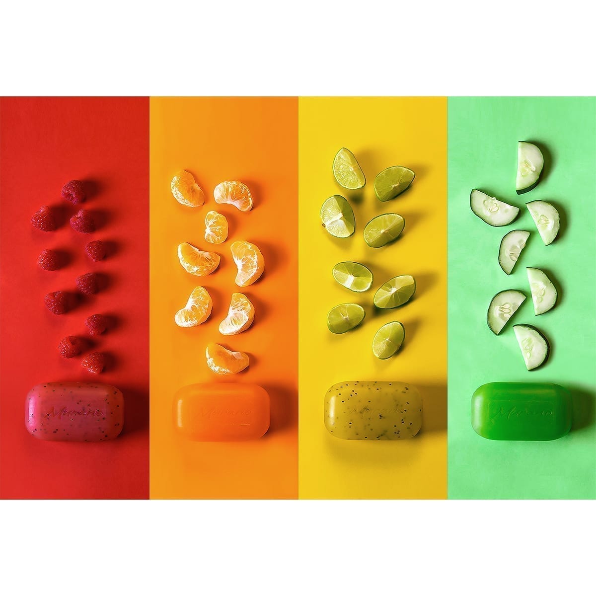 Murano: four color columns with translucent soap bars and fruit (raspberry, mandarin, lemon, cucumber) in a still-life layout. “100 Years of History” editorial project, Fábrica de Jabón La Corona — piece 1 of 38.