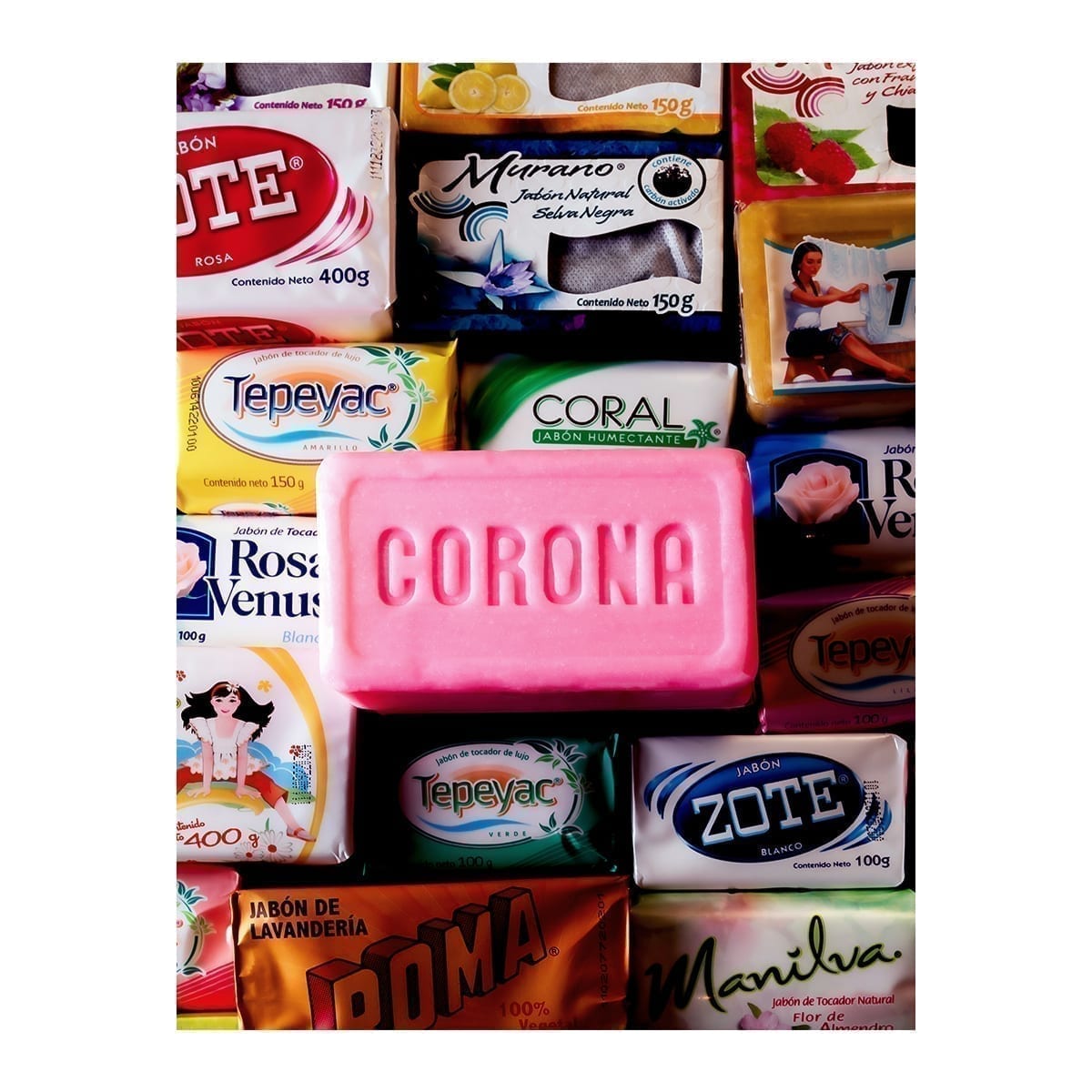 Collage of group-brand soap packs (Zote, Tepeyac, Roma, Rosa Venus, etc.) with a pink “CORONA” bar in front. “100 Years of History” editorial project, Fábrica de Jabón La Corona — piece 11 of 38.