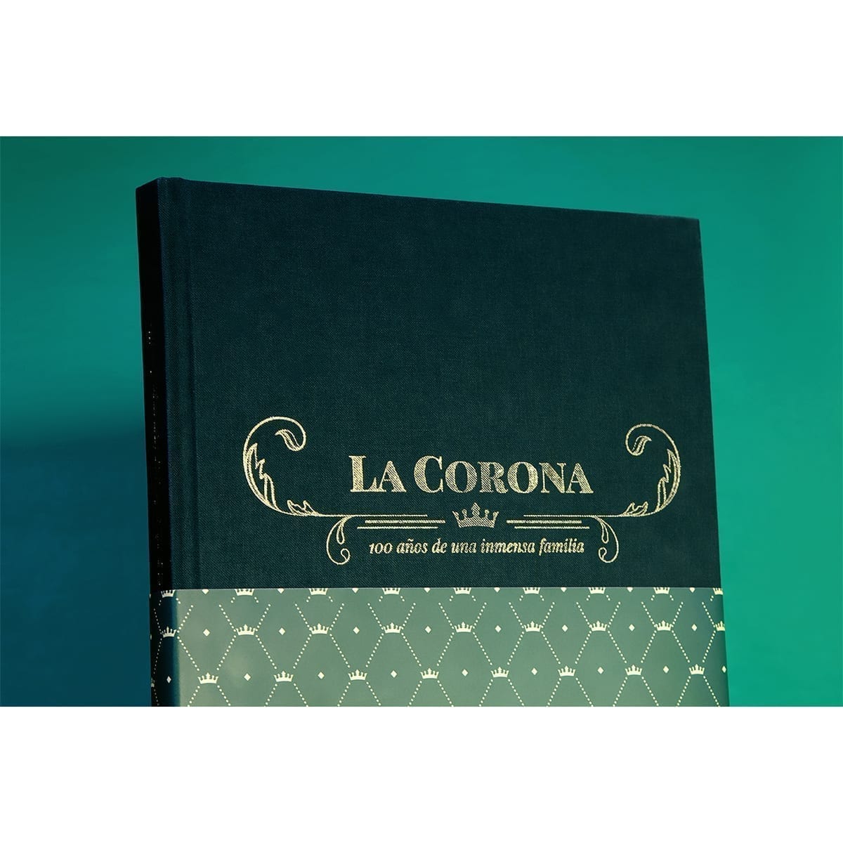 Front cover with lower crown lattice band; gold LA CORONA title and centenary subtitle on teal. “100 Years of History” editorial project, Fábrica de Jabón La Corona — piece 36 of 38.